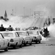 In this March 7, 1965, file photo tear gas fills the air as state troopers, ordered by Alabama Gov. George Wallace, break up a march at the Edmund Pettus Bridge in Selma, Ala., on what became known as Bloody Sunday.